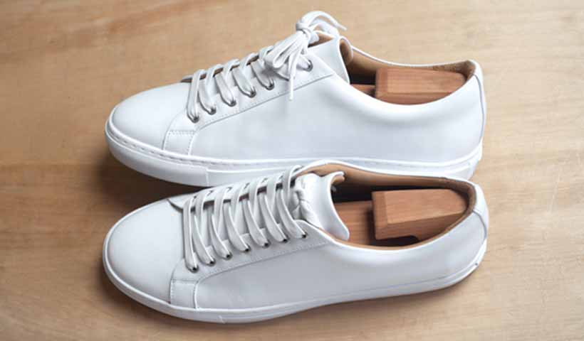 Wood shoe trees in white sneakers
